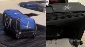 Why That Chalk “X” on Your Suitcase Shows Up and What It Means