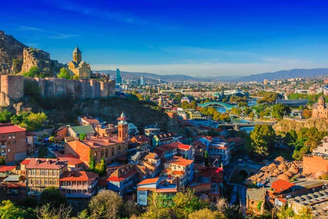 Georgia tourism showcasing Tbilisi old town, Caucasus mountains, ancient monasteries, wine vineyards, and Black Sea coast
