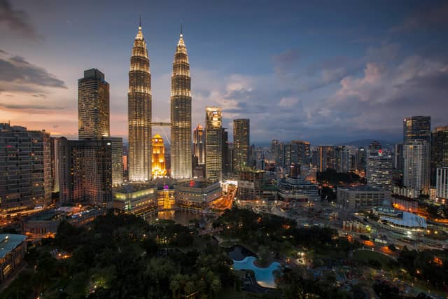 Malaysia tourism showcasing Petronas Twin Towers, tropical islands, heritage streets, rainforests, and diverse cultural landmarks