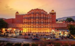 Hawa Mahal Jaipur front facade glowing at sunrise with intricate jharokha windows