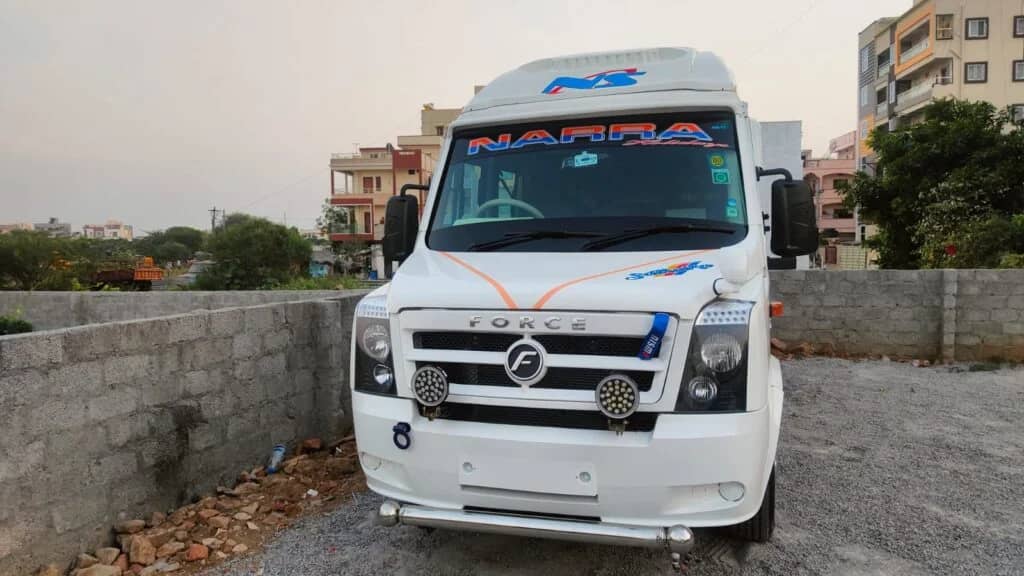 Force Tempo Traveller front side view showing luxury group travel van with bold exterior design