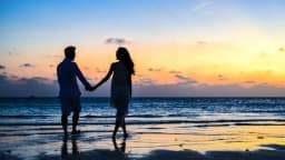 Romantic couple walking along a scenic beach in Puducherry during Valentine’s Day